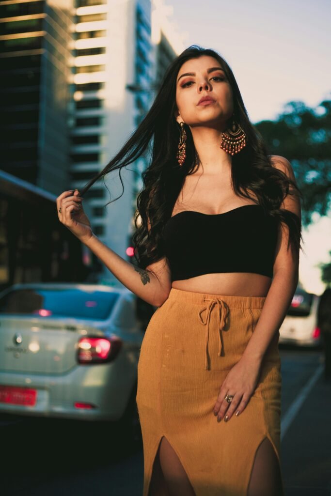 pexels-photo-1152994-1152994 Chic portrait of a young woman in urban setting wearing a crop top and stylish earrings.