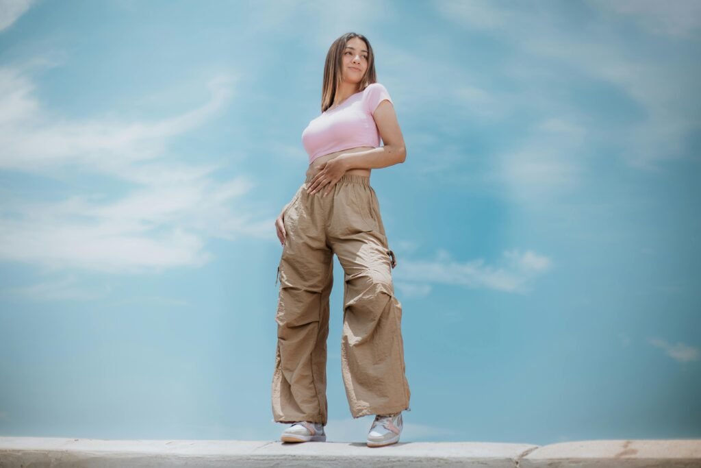 pexels-photo-15663726-15663726 Woman posing outdoors in casual clothing against a bright sky, showcasing modern fashion trends.